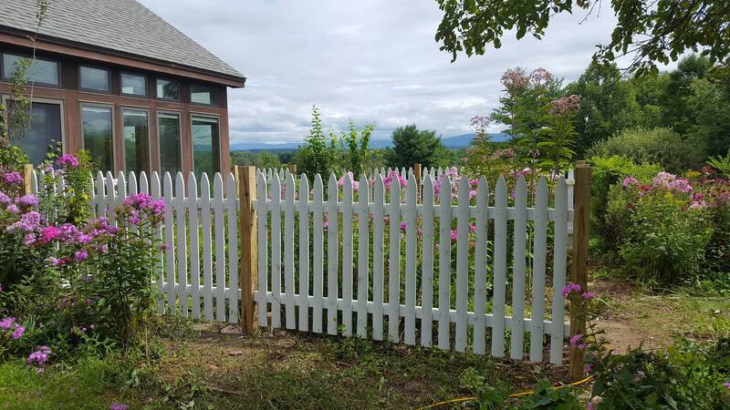 White picket fence around flower gardens