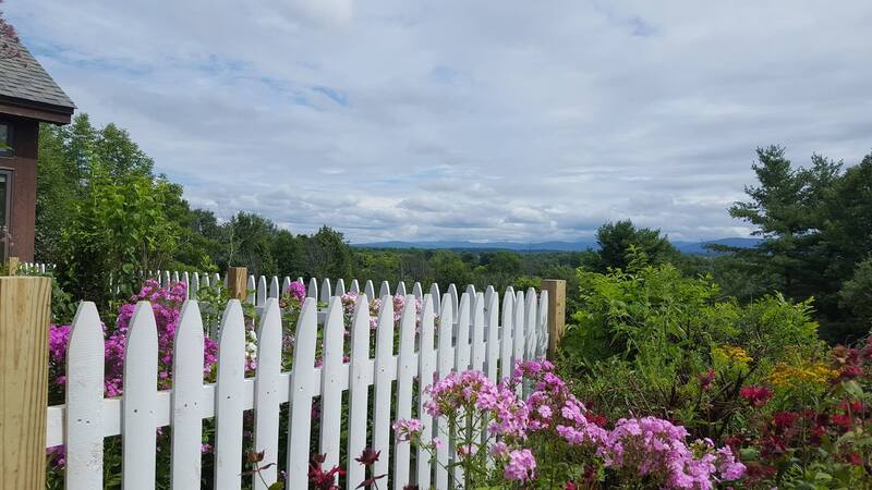 White picket fence around flower gardens