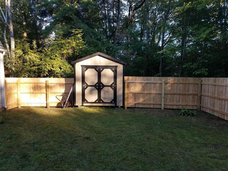Complete stockade cedar fence built around shed