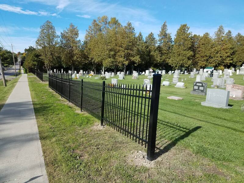 Decorative, black steel fence surround cemetery