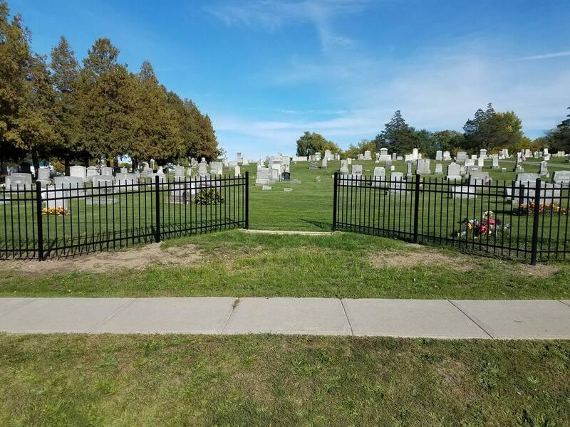 Decorative, black steel fence surround Cemetery