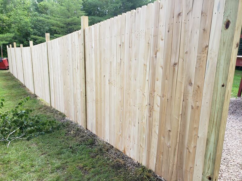 Solid board dog ear fence under construction