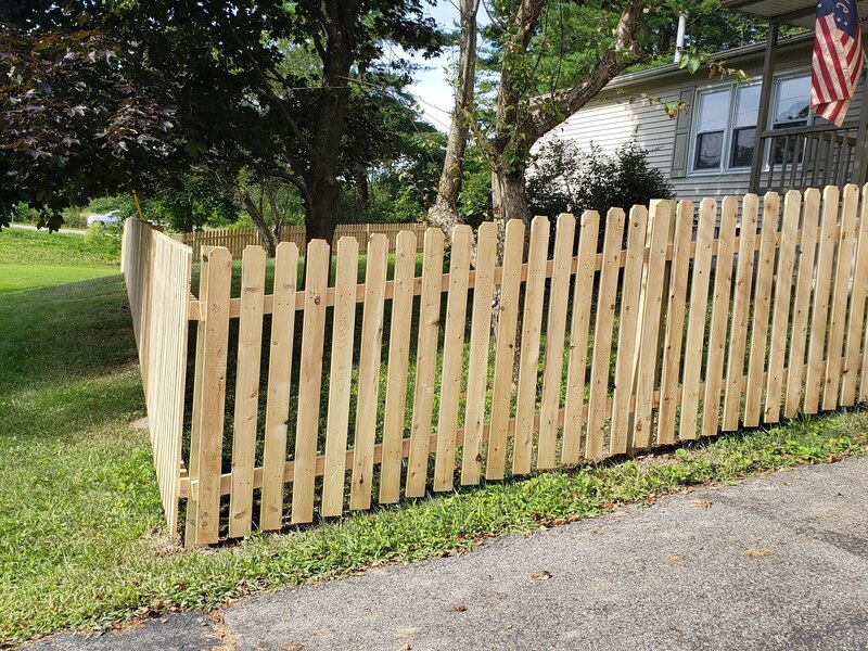 Natural dog ear picket fence around small yard