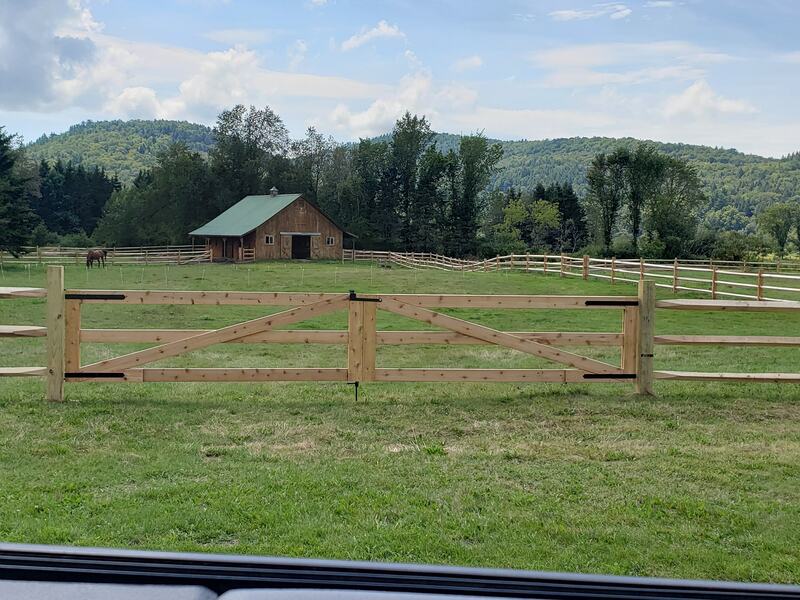 Natural wood split rail and post fencing with large gate for animal access