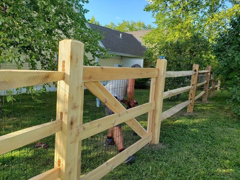Natural wood split rail and post fencing and gate entrance